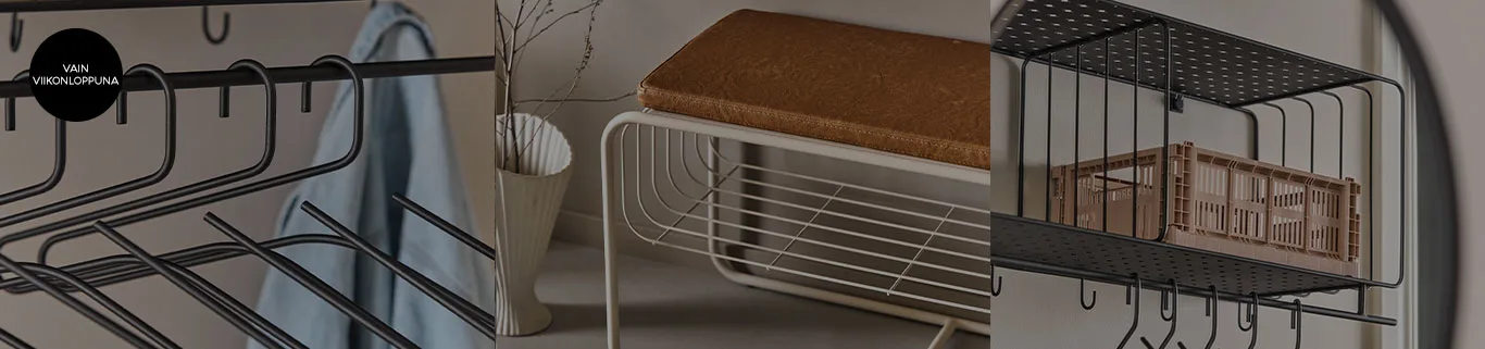 Mustia metallihenkareita, valkoinen penkki ruskealla istuintyynyllä ja musta hyllykkö vaaleanruskealla korilla.