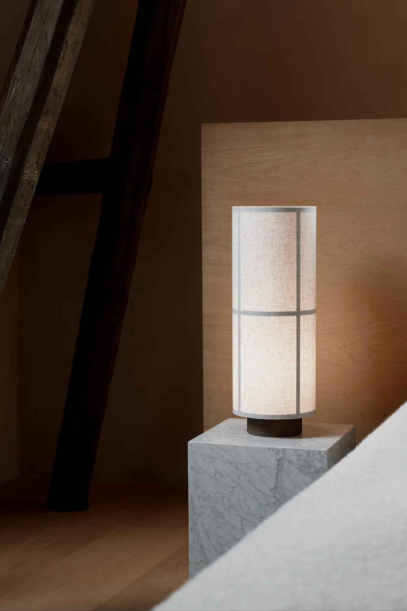 Harmaalla marmorisella yöpöydällä seisoo Audo Copenhagenin Japandi-tyylinen Hashira-pöytävalaisin.