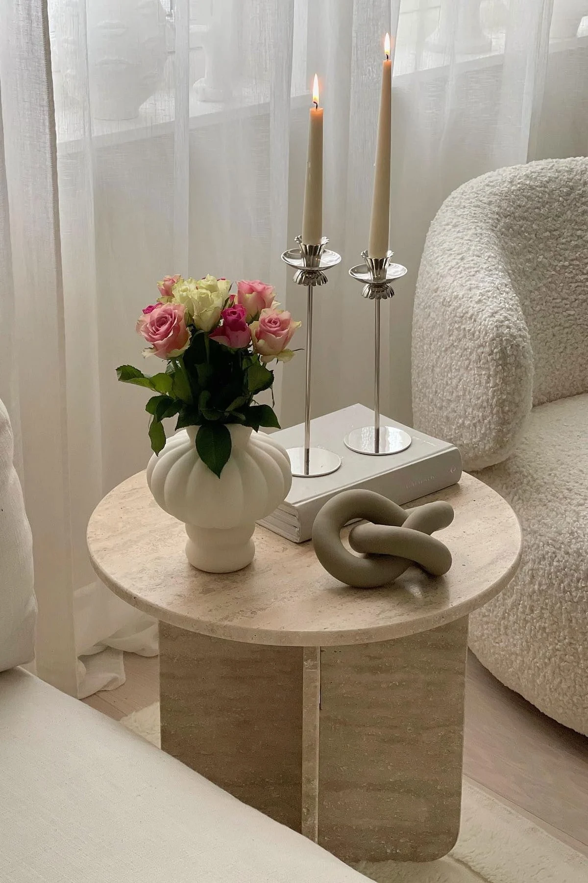 Koristeltu sohvapöytä, jossa on Louise Roe Balloon -maljakko, kirja, kaksi kynttilänjalkaa ja Cooee Designin Knot-koriste.